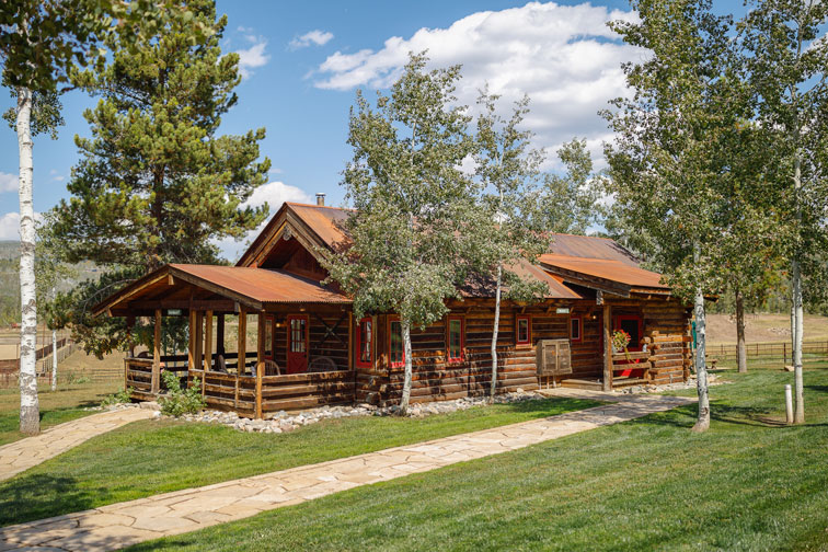 A cozy guest cabin with rustic charm at The Home Ranch in Colorado.