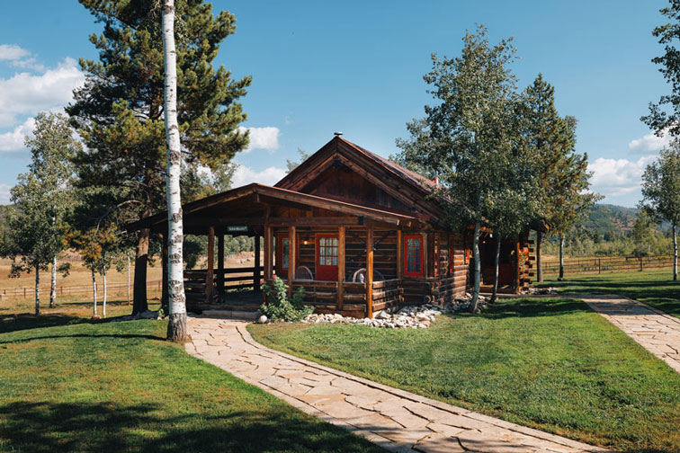 A cozy guest cabin with rustic charm at The Home Ranch in Colorado.