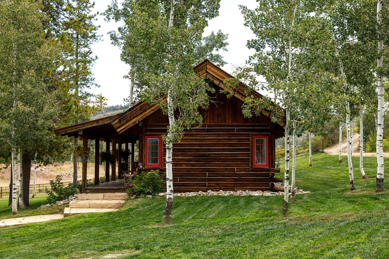 The exterior of a family cabin at The Home Ranch in Colorado.