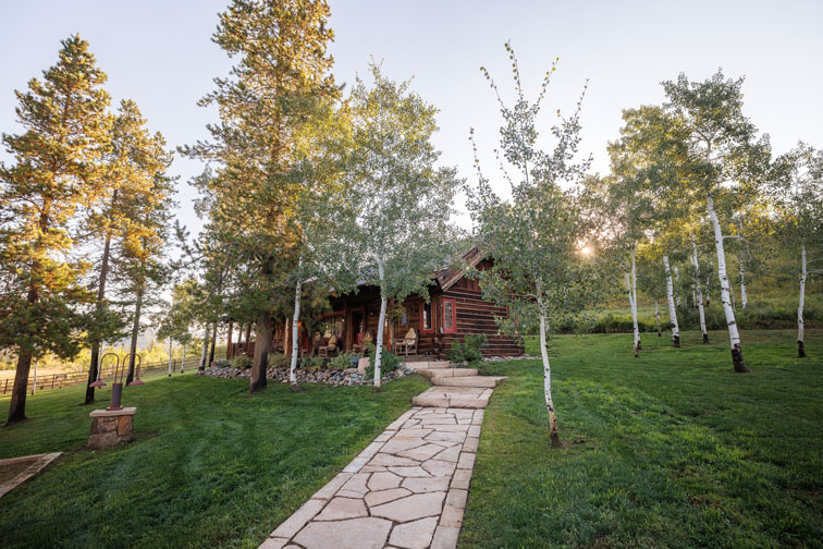 The exterior of a family cabin at The Home Ranch in Colorado.