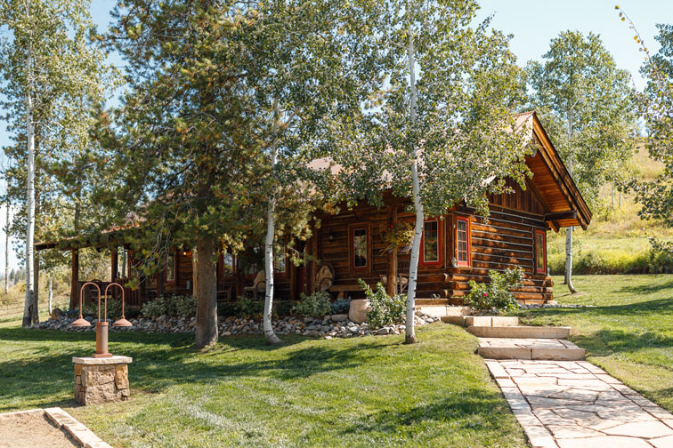 The exterior of a family cabin at The Home Ranch in Colorado.