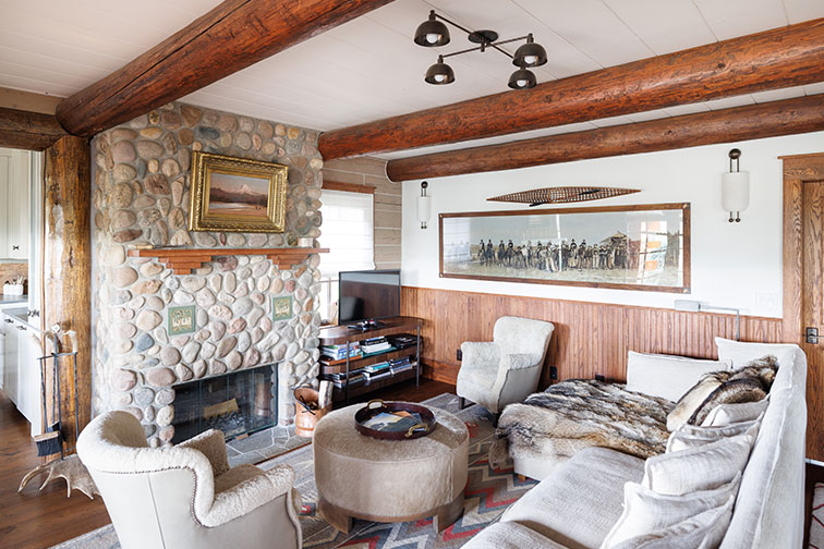 A cozy stone fireplace and living room in luxury The Home Ranch cabin in Clark, Colorado.