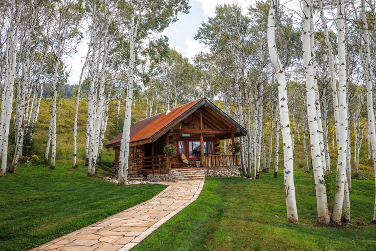 Exterior of a cozy hideaway cabin at The Home Ranch in Colorado.