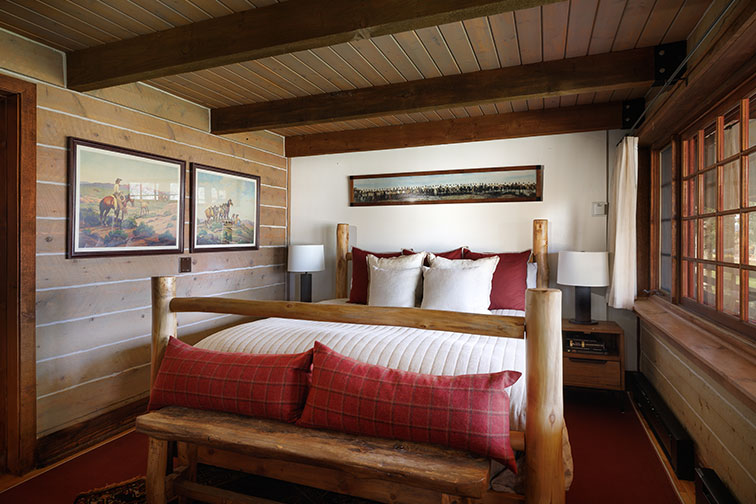 Bedroom of a traditional wood cabin in Clark, Colorado.