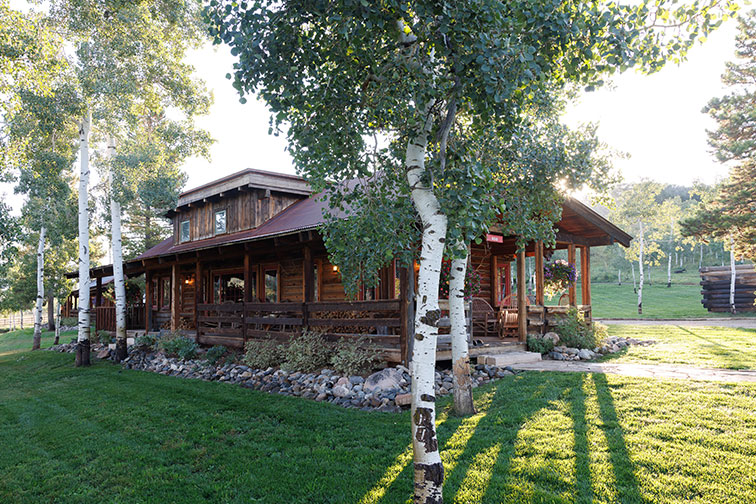 Exterior of a luxury guest cabin with traditional feel at The Home Ranch.