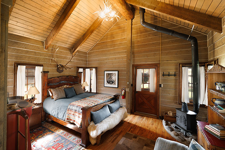 Cozy bedroom in a guest cabin at The Home Ranch in Colorado.