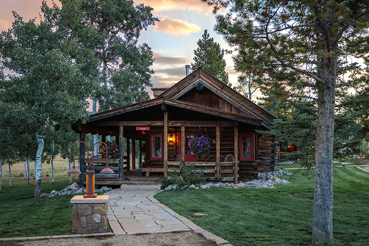 Exterior of a luxury guest cabin with traditional feel at The Home Ranch.