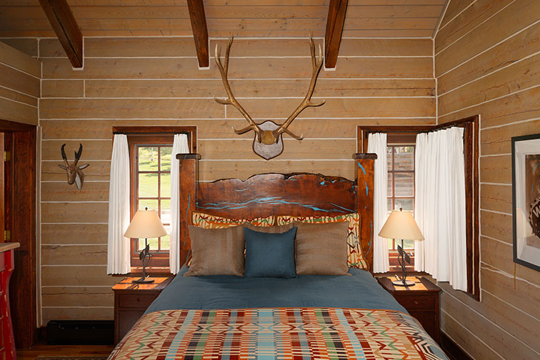 Cozy bedroom of a luxury guest cabin at The Home Ranch.