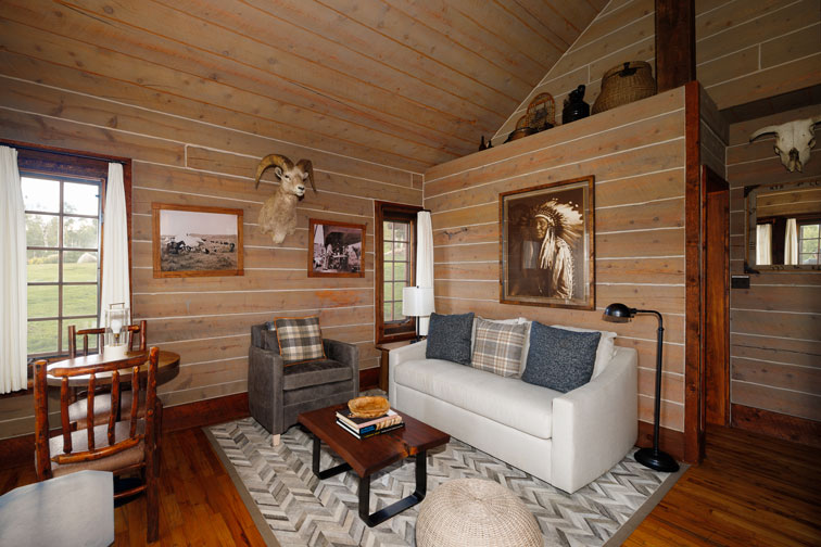 The living area of a romantic guest cabin at the Home Ranch in Colorado.