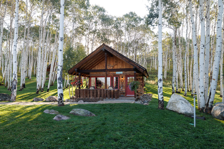 The exterior of a romantic guest cabin at the Home Ranch in Colorado.