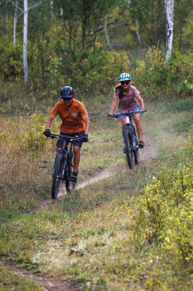 Mountain biking down a trail