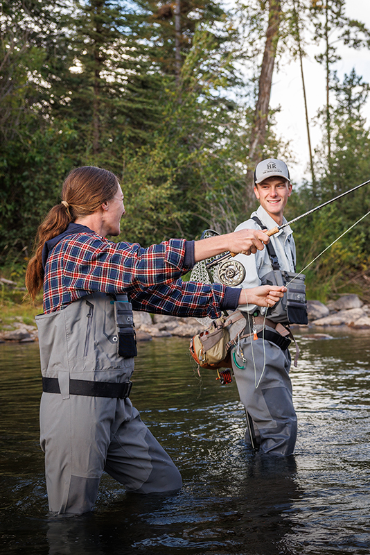 A couple enjoying a fishing adventure at The Home Ranch in Clark, Colorado.