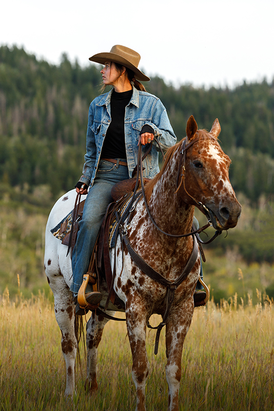 Horseback rider at the luxury ranch experience at The Home Ranch in Clark, Colorado.