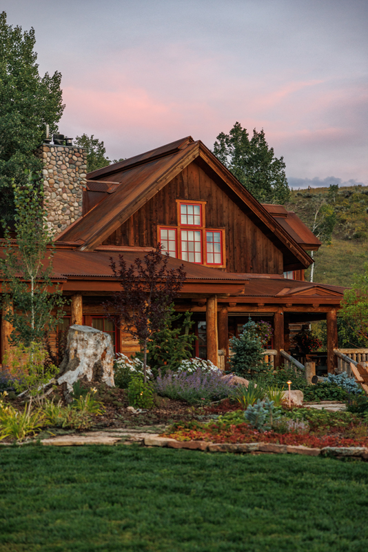 The exterior of the rustic-luxe guest house at The Home Ranch in Colorado.