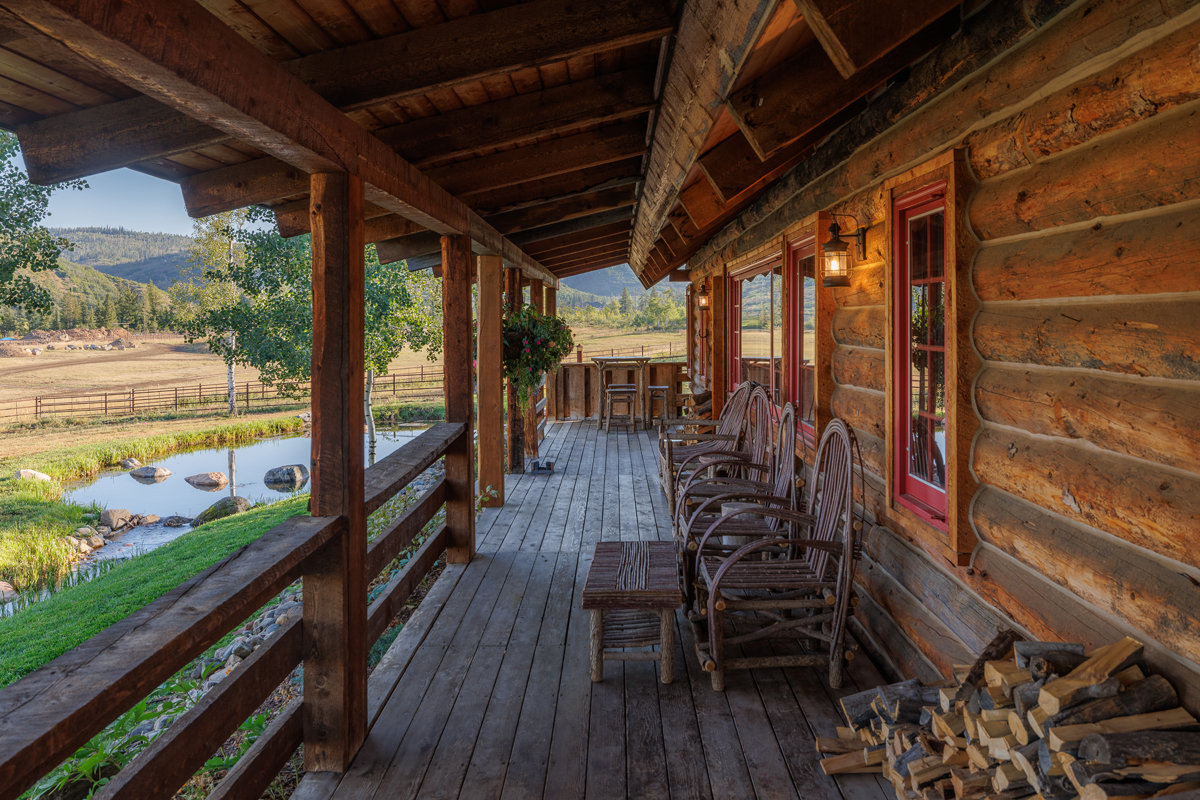 A spacious deck overlooking the grounds of the Birdhouse guest cabin at The Home Ranch in Colorado.