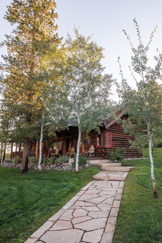 Wood cabin exterior of a guest suite at The Home Ranch in Colorado.