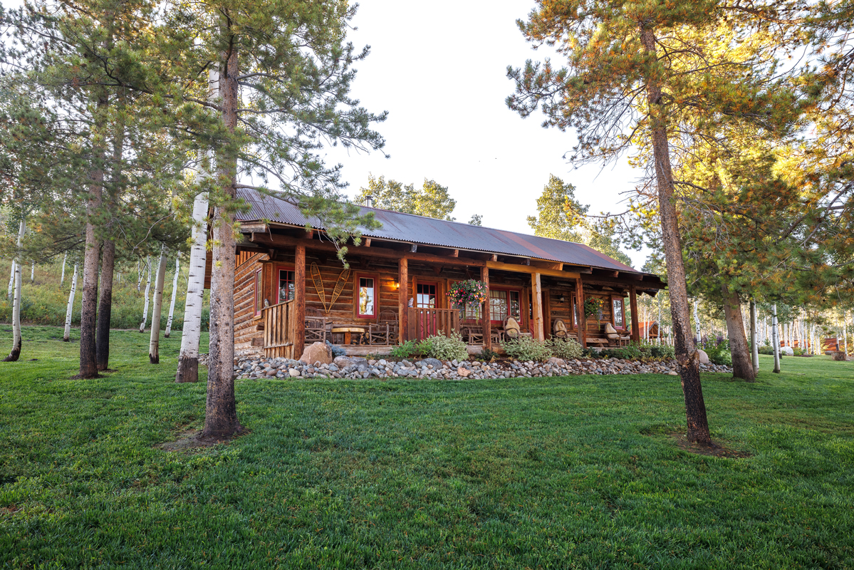 Wood cabin exterior of a guest suite at The Home Ranch in Colorado.