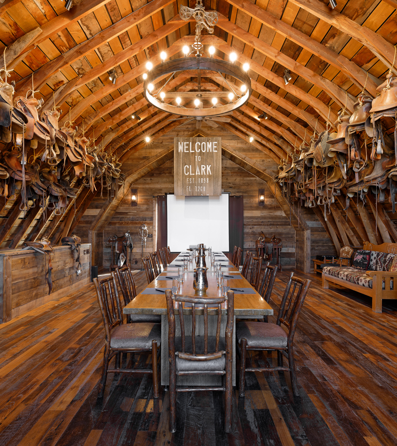 Flanked with suspended saddles the newly renovated historic Hahn's Peak Barn at The Home Ranch in Colorado also boasts a dance hall for an unforgettable private reception.