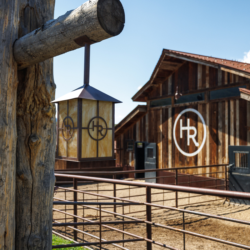 The wooden horse barn at The Home Ranch's equine at performance horse program.