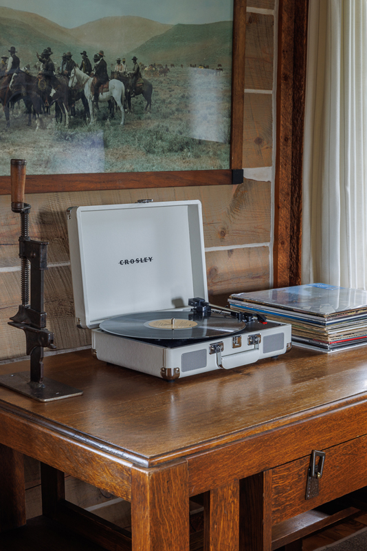 A retro record player completes the cozy guest cabin, the Compromise, at The Home Ranch in Colorado.