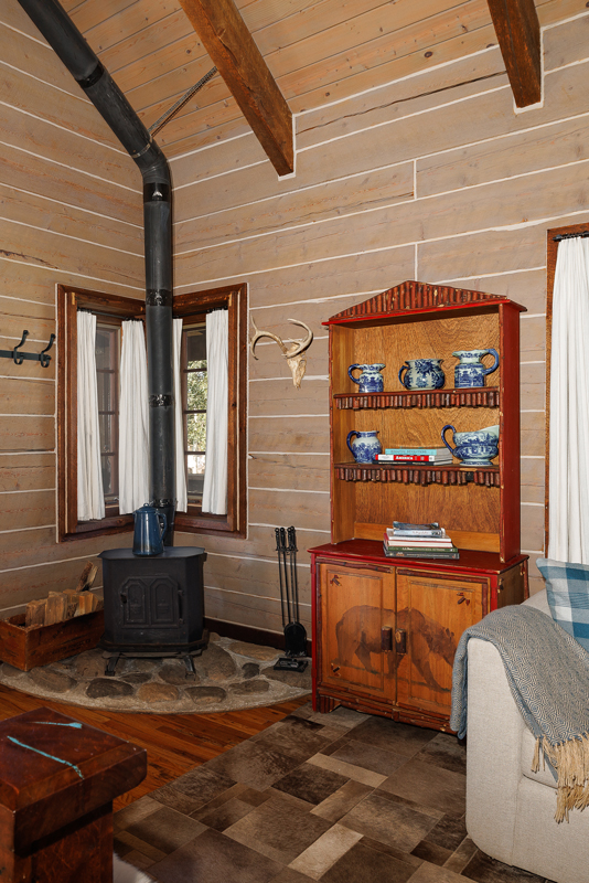 Wood burning stove in the studio style cabin at Home Ranch in Clark, Colorado.