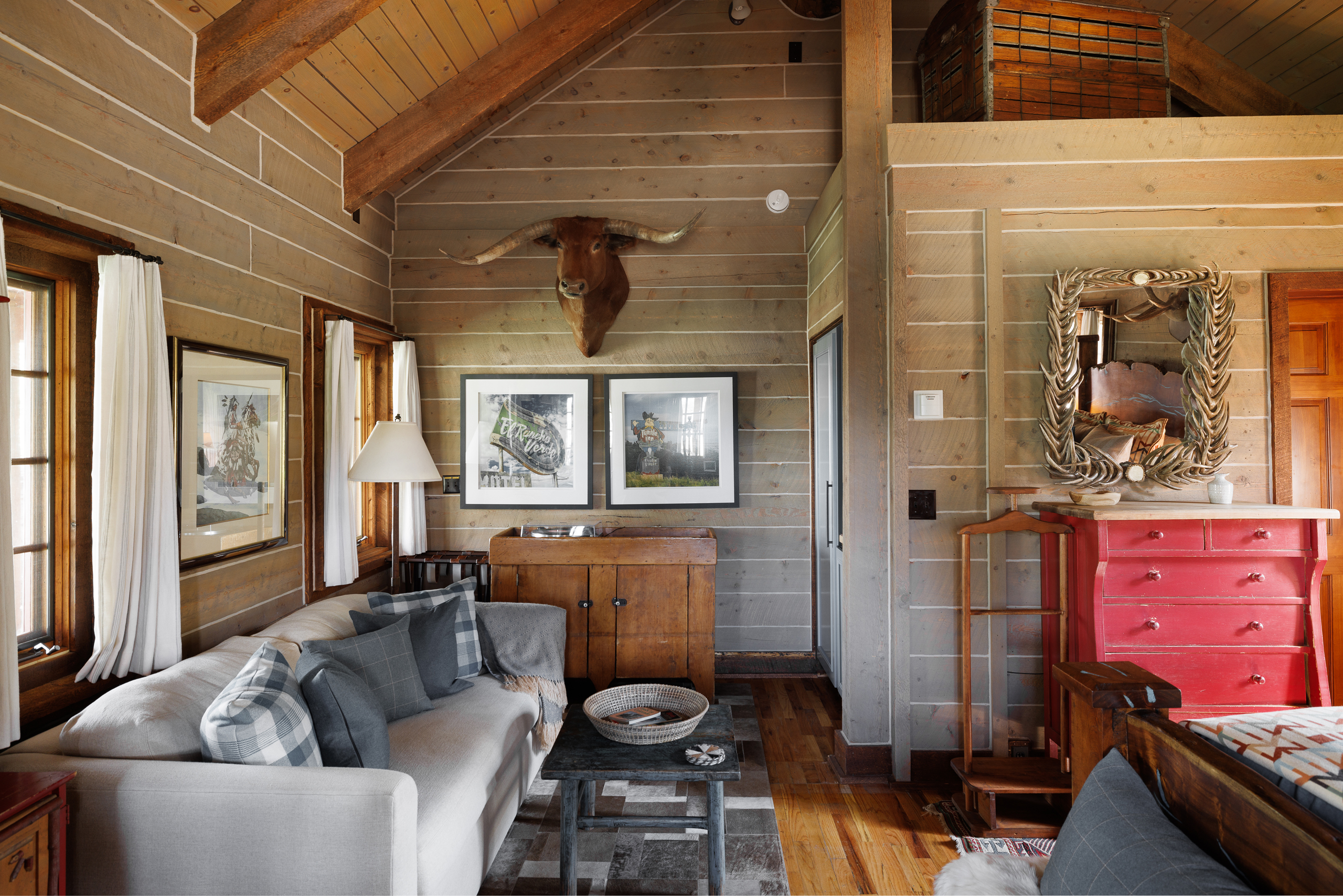 Inside the studio-style retreat, Roo, at The Home Ranch in Colorado. Bark-covered ceilings, warm wood touches, and antler-inspired decor set an instantly inviting mood.