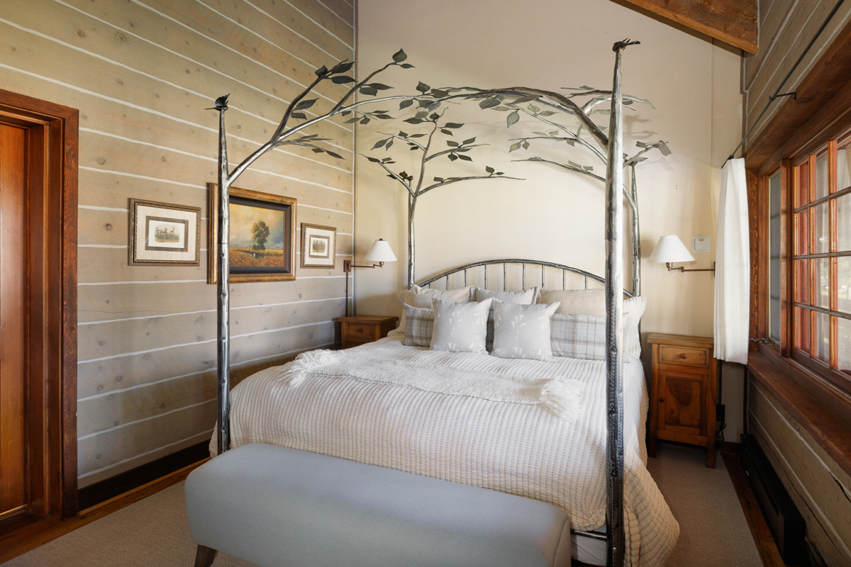 A cozy canopy bed in a guest cabin at The Home Ranch in Colorado.