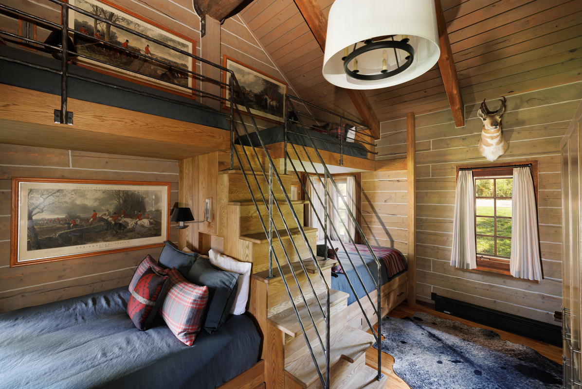 Two twin-over-queen bunk beds with a wooden staircase to the upper bunks in this Colorado guest ranch bunkhouse.