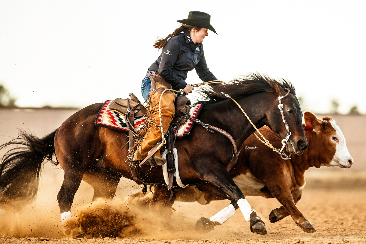 Renowned trainer, Gusti Buerger roping a horse. She has returned to her home state to lead The Home Ranch’s performance horse program.