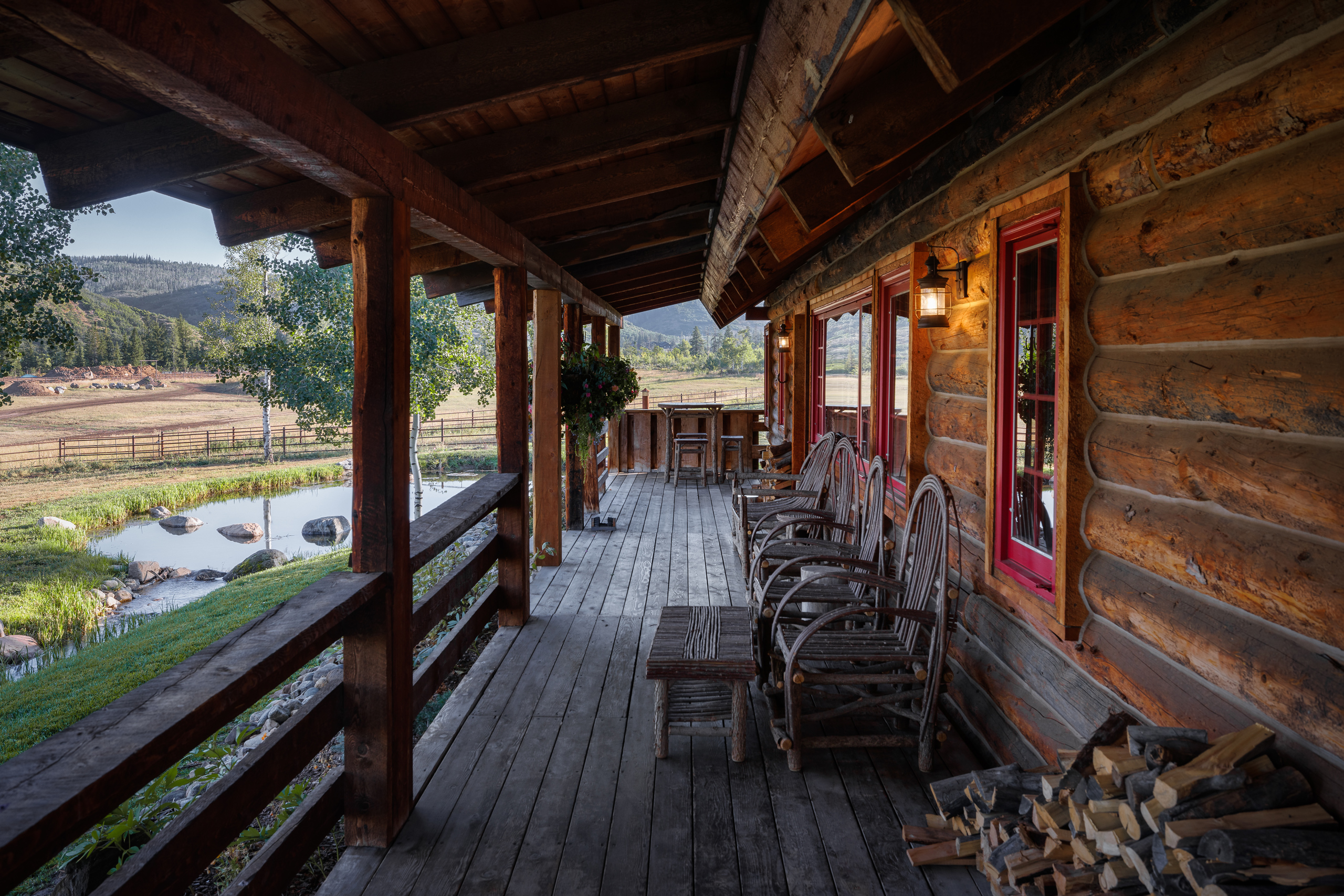 The Home Ranch in Colorado offers cozy guest cabins with rustic charm. This cabin has a welcoming front porch and a cozy exterior that will make you feel right at home.