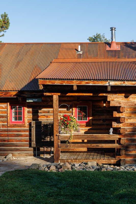 The exterior of a cozy guest cabin at The Home Ranch in Clark, Colorado.