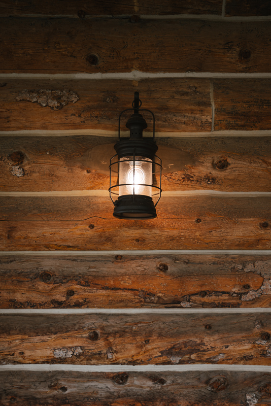 An exterior lantern on a cozy guest cabin at The Home Ranch in Clark, Colorado.