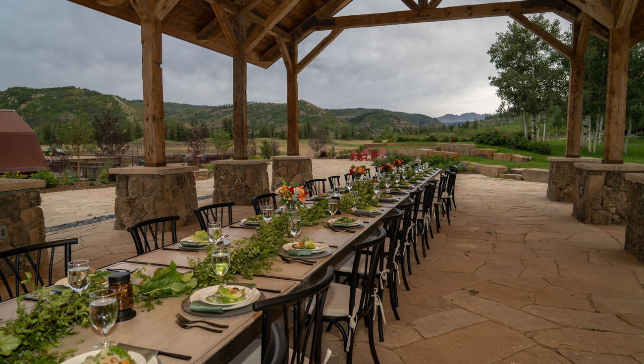 long table setting in outdoor stone pavilion