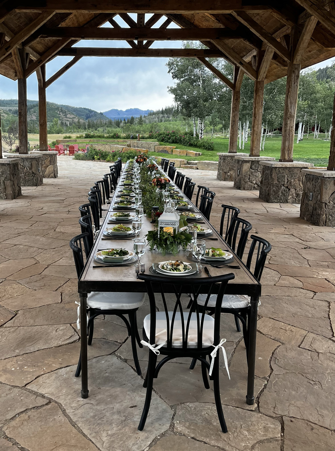 long table setting in a stone pavilion
