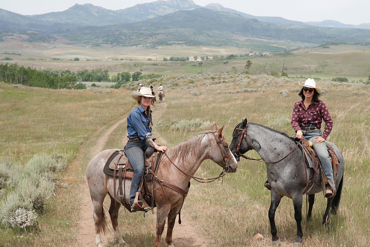 Horseback riding on the trails of The Home Ranch in Colorado.