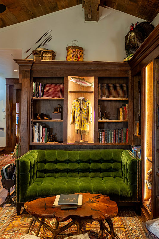 Lush velvet couch area with Native American art at The Home Ranch in Clark, Colorado.