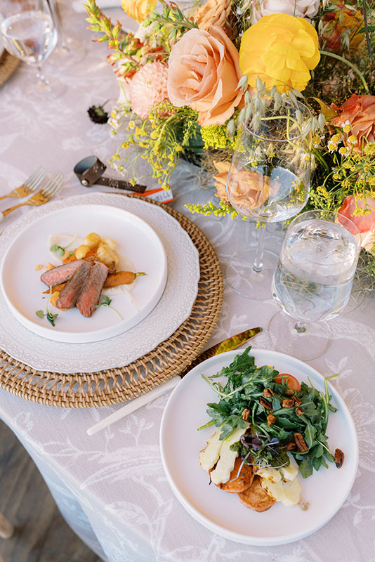 Plated, elegant meal of American grass-fed wagyu beef from The Home Ranch in Colorado, paired with a fresh green salad.