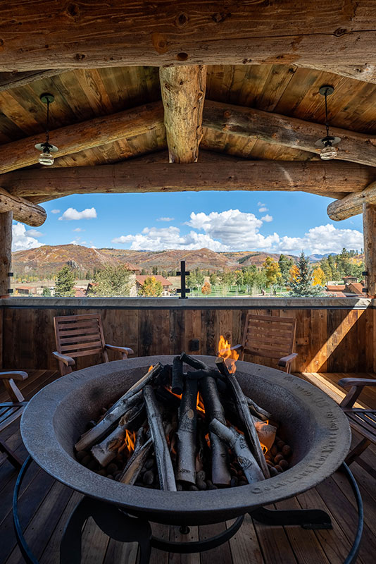 Outdoor firepit on porch at The Lodge, a two-room suite at The Home Ranch in Colorado.