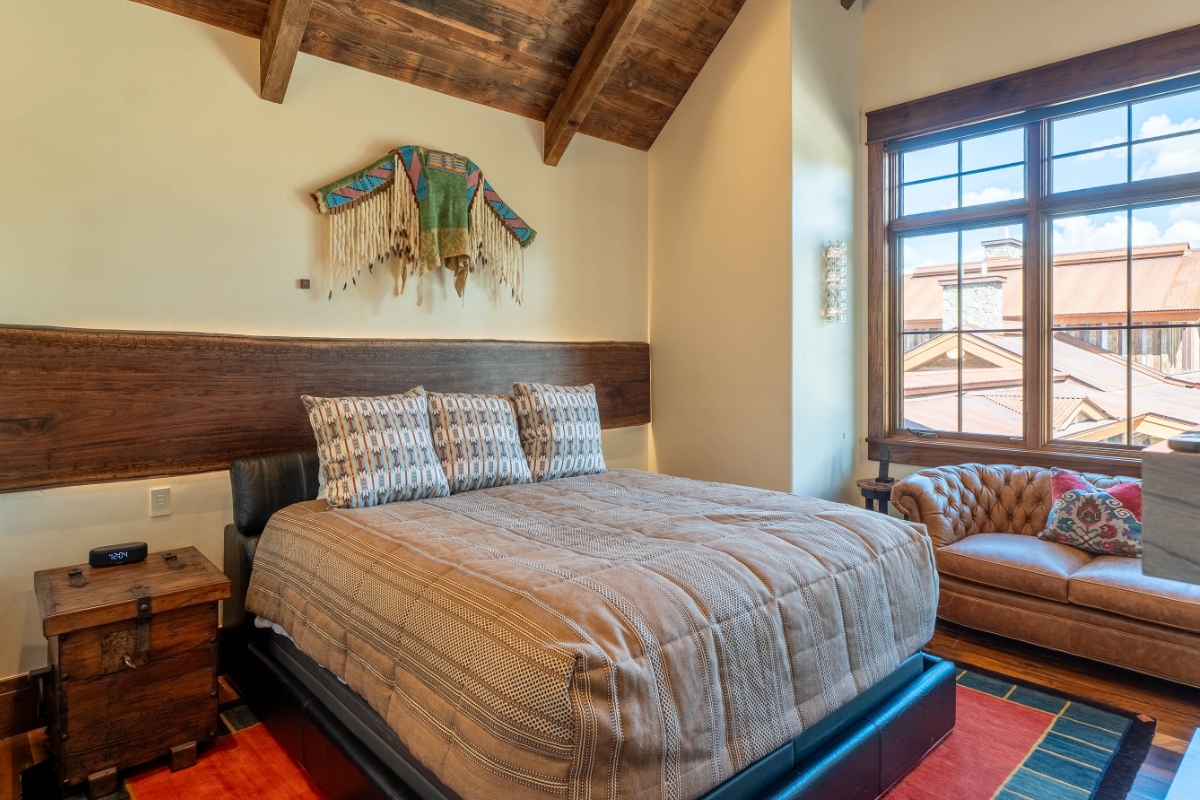 Bedroom inside the Hideaway suite at The Lodge, a two-room suite at The Home Ranch in Colorado.